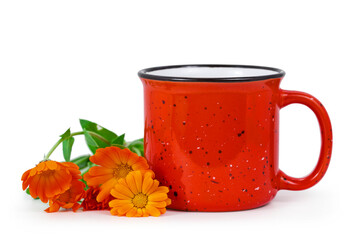 Red enamel cup of tea with calendula flowers isolated on a white background.