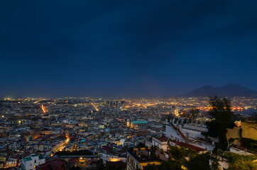 View of Naples at night and Vesuvius volcano in the background