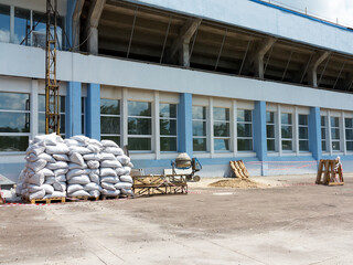 White sandbags on construction site during reconstruction of old stadium.