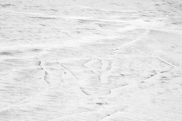 Ice covered with white snow as an abstract winter background