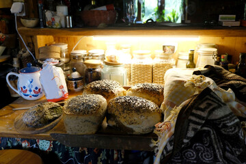 The breads wich grain freshly baked at home are lying on the top of the cupboard.