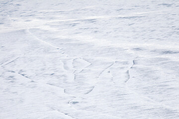 Ice covered with white snow as an abstract winter background
