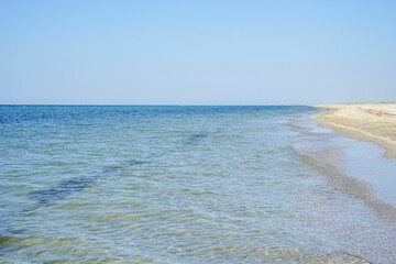 azure sea with clear waters off the coast of a white sand island