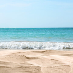Ocean waves rolling on sandy beach, closeup view
