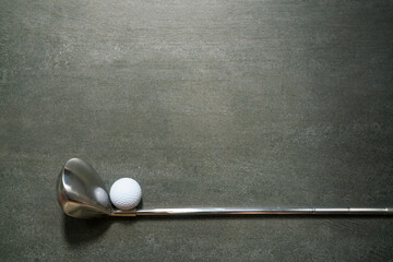 golf ball and golf club on black table background