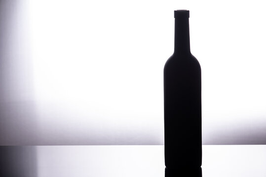 Front view red wine blank bottle isolated on white background.