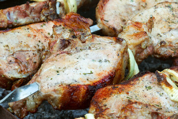 Grilled kebab cooking on metal skewer. Roasted meat cooked at barbecue. BBQ fresh beef meat chop slices. Traditional eastern dish, shish kebab. Grill on charcoal and flame, picnic, street food