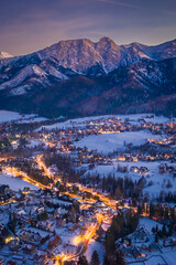 Snowy Illuminated Zakopane city at night, aerial view © shaiith