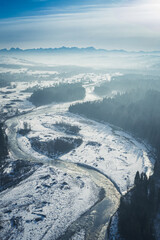 Frozen Bialka river in winter at sunset, aerial view
