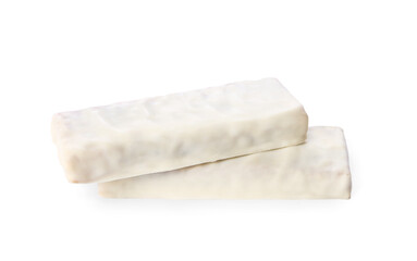Crunchy granola bars covered with icing on white background