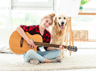 Girl playing guitar with lovely dog