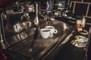 Close up shot of clean espresso maker with two cups preparing fresh espresso coffee at the bar.