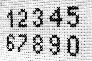 numbers embroidered on the canvas