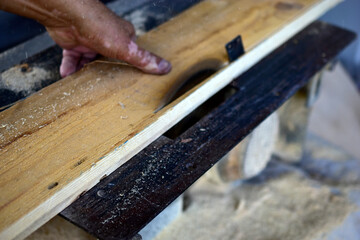 Working with a circular saw of a person with pigmentation of the skin of the hands