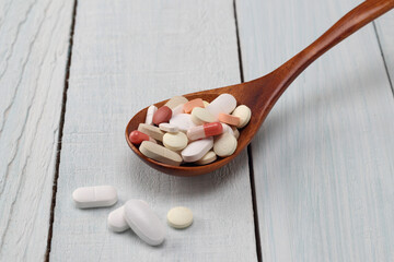 tablets and capsule in a spoon 