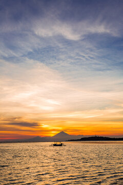 Volcano and ocean with last sunrays at the blue hour