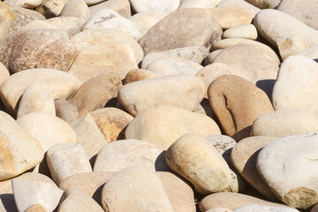 lot of stones close-up on beach, pebbles as textured background