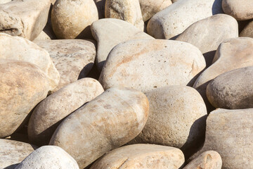 lot of stones close-up on beach, pebbles as textured background