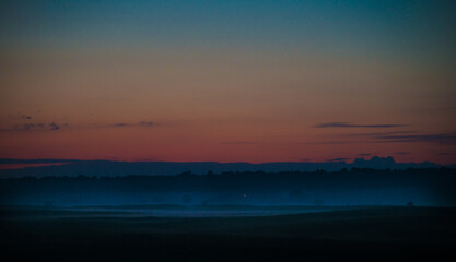 Fototapeta na wymiar Sunset with fog in the plain