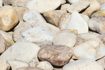 lot of stones close-up on beach, pebbles as textured background