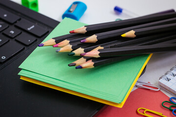 school stationery Notepad, pencils, writing paper on a light background