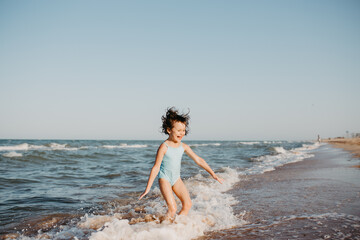 Fototapeta na wymiar happy kids playing on beach in the day time