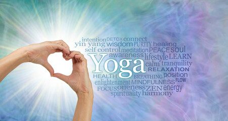 Words associated with the benefits of YOGA - female hands making a heart shape with light burst...