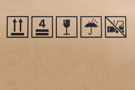 Black fragile sign icons on cardboard. Package box with symbol indicating fragile item, Need careful handling.