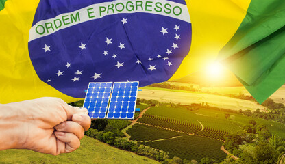 Solar panel photovoltaic plant with brazilian flag at sunset
