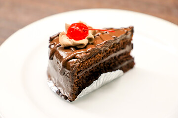 Chocolate cake with cherries and chocolate cream.