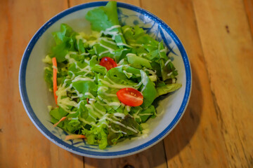 Salad on a wooden table dish