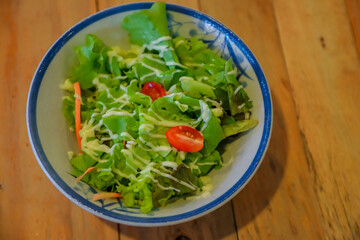 Salad on a wooden table dish
