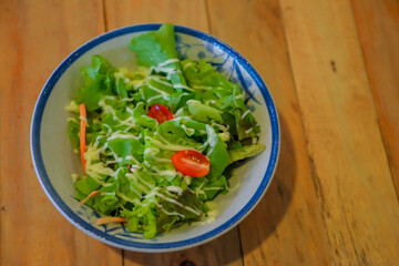 Salad on a wooden table dish