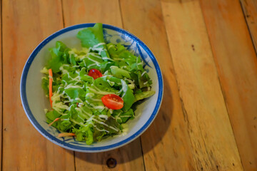 Salad on a wooden table dish