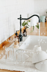 Clean glasses and dishes on towel on the kitchen table after washing
