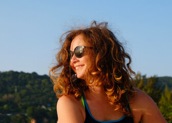 happy young woman in sunglasses smiling on the beach sunset ocean 