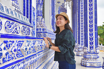 Tourist female on holiday vacation trips at temple on thailand