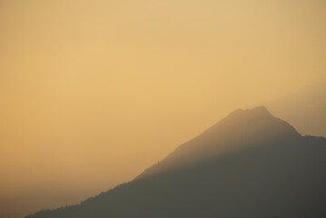 A mountain illuminated by the golden glow of sunset