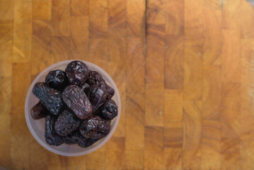 Pile of dried date palm isolated on wooden cutting board