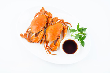 A dish of delicious steamed red sturgeon crab on white background