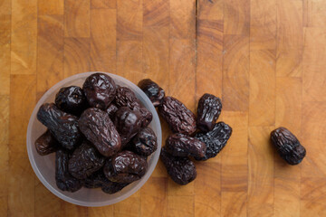 Pile of dried date palm isolated on wooden cutting board
