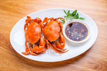 A dish of delicious steamed red sturgeon crab on wooden table