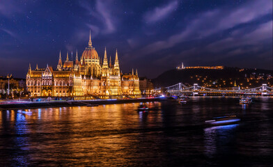 Fototapeta na wymiar Budapest night view cityscape. Parliament and starry sky on background. Hungary. Popular Travel destinations