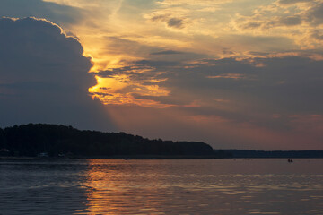Naklejka na ściany i meble Horizontal image of a sunset over a lake. Evening sun.