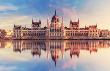 Fototapeta premium Incredible front view on Parliament building in Budapest with fantastic perfect sky and reflection in water. calm Danube river. Popular Travel destinations. creative image used as background.