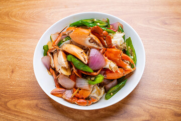 A dish of delicious spicy blue crabs on a wooden table