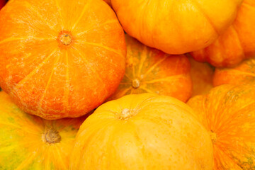 Pumpkins in vegetable shop,  Fresh cherry tomatoes in box 