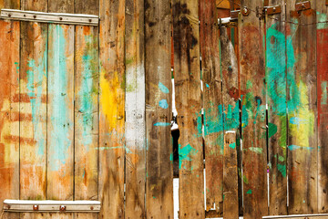 Texture of weathered wooden wall. Falling snow, in winter. Aged wooden plank fence of vertical flat boards