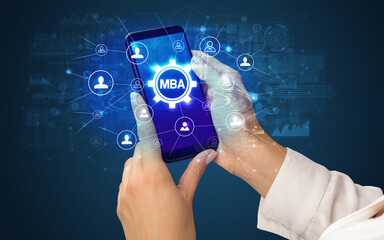 Female hand holding smartphone with MBA abbreviation, modern technology concept