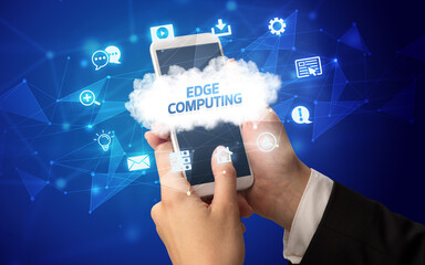 Female hand holding smartphone with EDGE COMPUTING inscription, cloud technology concept